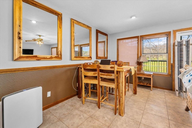 tiled dining space with a textured ceiling