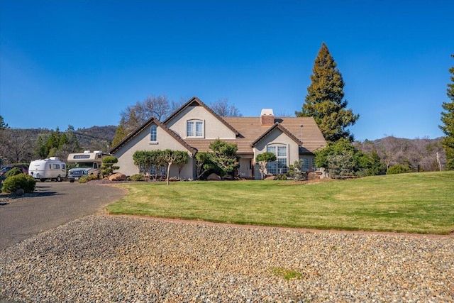 view of front facade with a mountain view and a front lawn