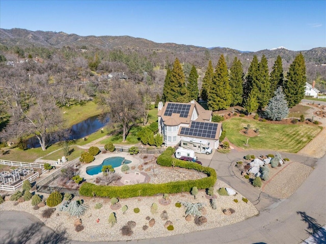 birds eye view of property with a water and mountain view