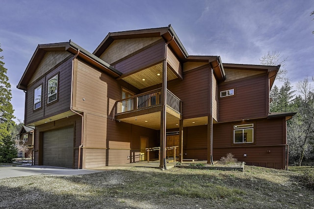 view of front of home with a balcony and a garage