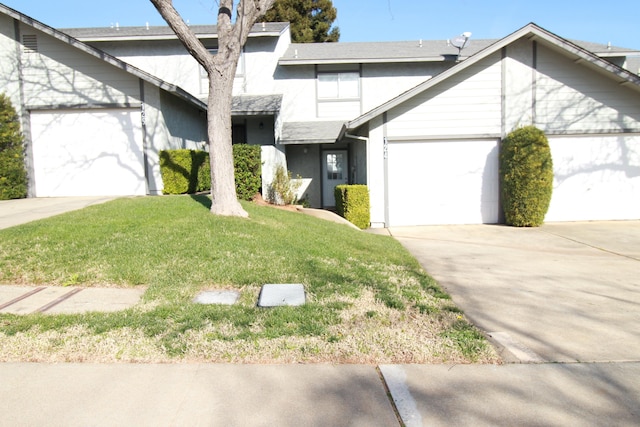 view of front of house with a garage and a front lawn