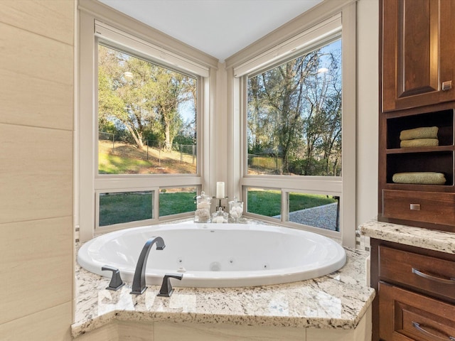 bathroom with a relaxing tiled tub