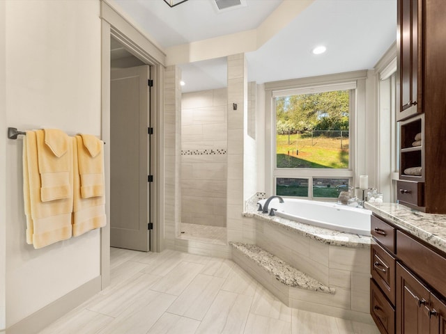 bathroom with shower with separate bathtub and vanity