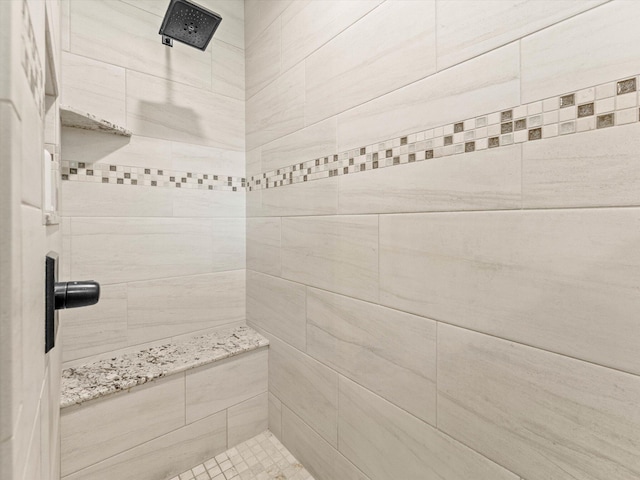 bathroom with tiled shower