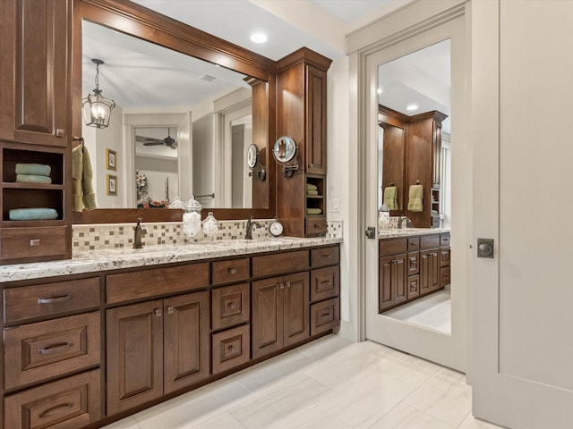 bathroom with tasteful backsplash and vanity