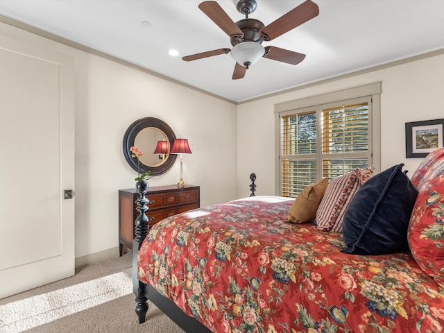 carpeted bedroom featuring crown molding and ceiling fan