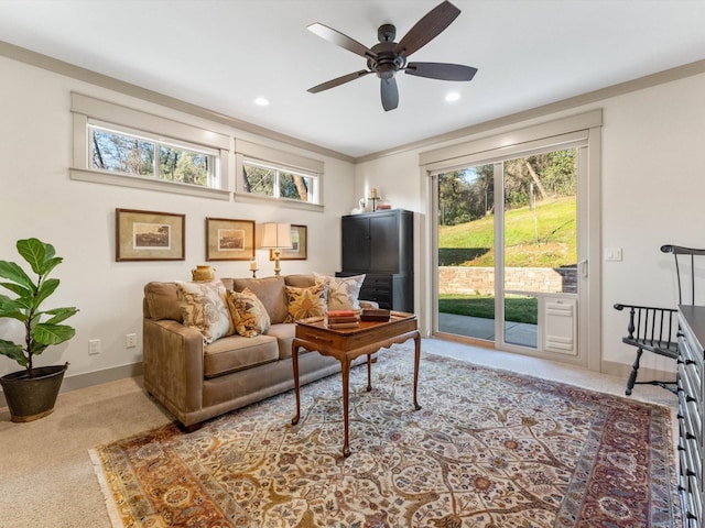 carpeted living room with ceiling fan and a healthy amount of sunlight