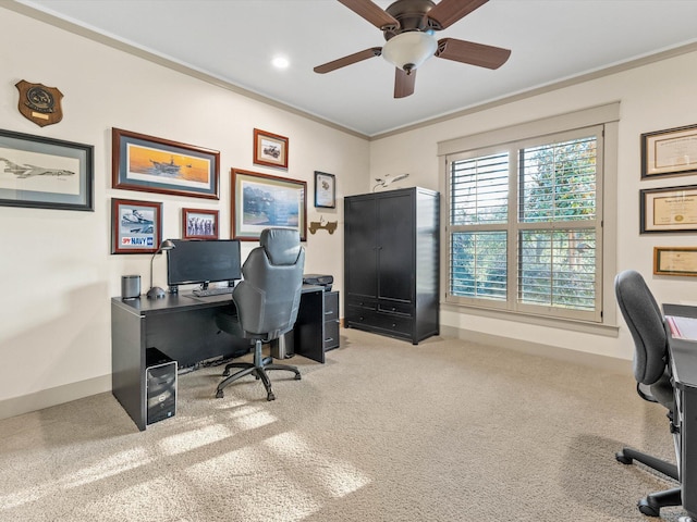 office space featuring ceiling fan, ornamental molding, and light carpet