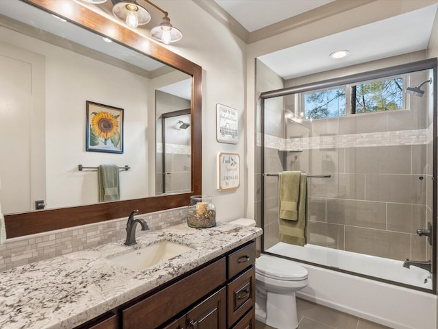 full bathroom with tasteful backsplash, tile patterned flooring, vanity, enclosed tub / shower combo, and toilet