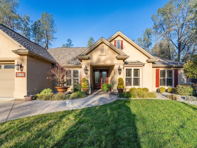 view of front facade featuring french doors, a garage, and a front lawn