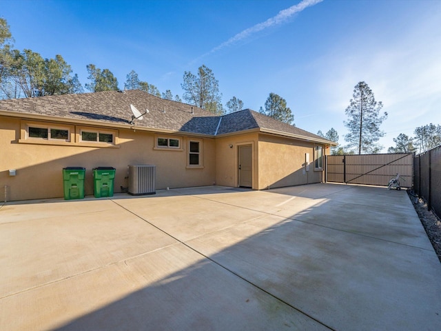 back of property featuring central AC and a patio area