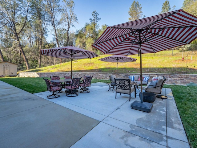 view of patio / terrace featuring an outdoor hangout area and a storage shed