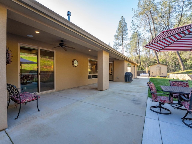 view of patio / terrace featuring grilling area, ceiling fan, and a storage unit