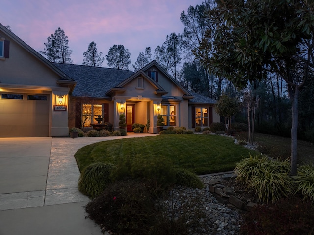 craftsman-style house with a yard and a garage