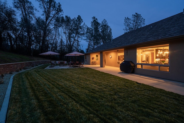 yard at dusk with a patio