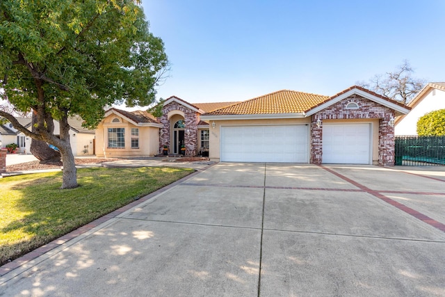 view of front of home with a garage and a front lawn