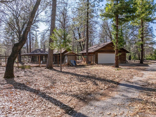 ranch-style house with a garage and an outdoor structure