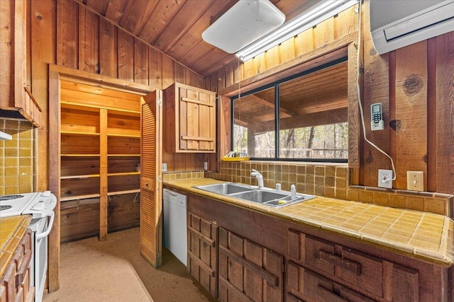 kitchen with sink, tile counters, backsplash, and white appliances