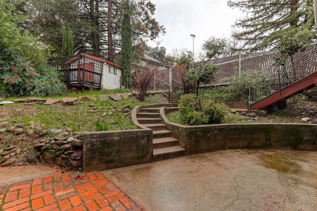 view of yard with fence and stairs