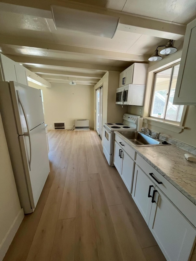 kitchen featuring white appliances, a sink, light wood-style floors, white cabinets, and beamed ceiling