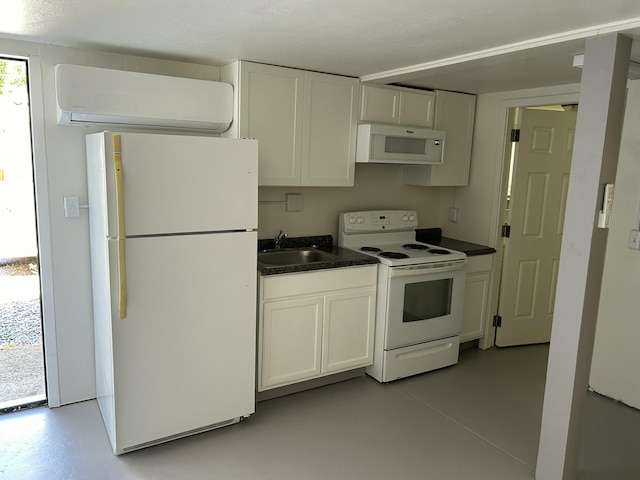 kitchen featuring white appliances, dark countertops, and white cabinetry