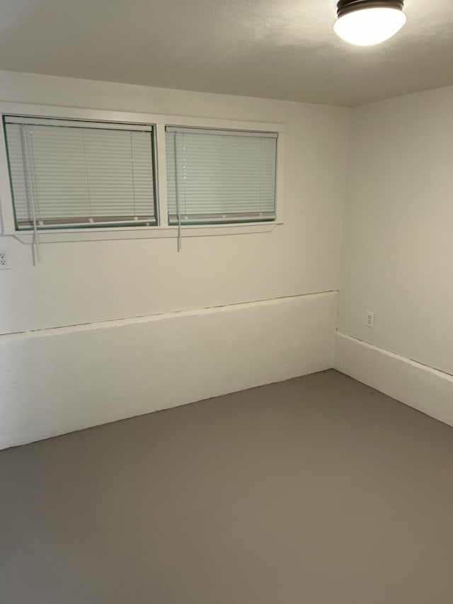 spare room with concrete floors