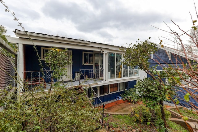 rear view of property featuring fence