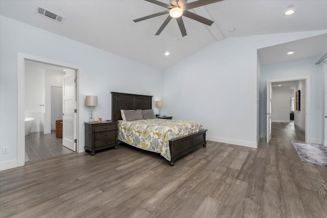 bedroom featuring ceiling fan, ensuite bath, lofted ceiling, and dark hardwood / wood-style flooring