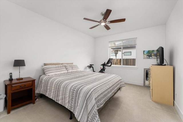 bedroom with ceiling fan and light carpet