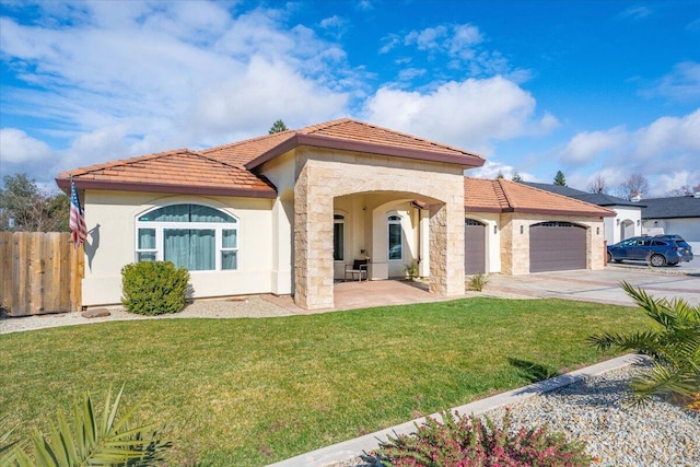 mediterranean / spanish-style house with a garage and a front yard