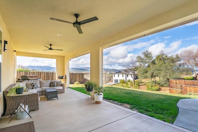 view of patio with a mountain view, outdoor lounge area, and ceiling fan