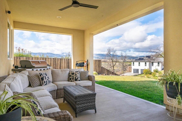 view of patio / terrace with a mountain view, an outdoor hangout area, and ceiling fan