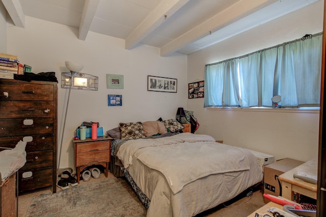 carpeted bedroom featuring beamed ceiling