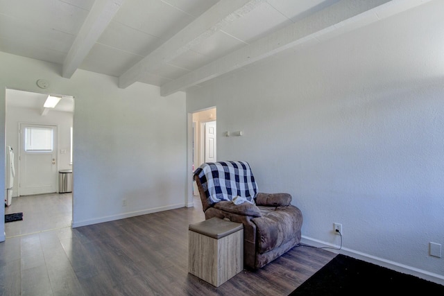 sitting room featuring beamed ceiling and dark hardwood / wood-style floors