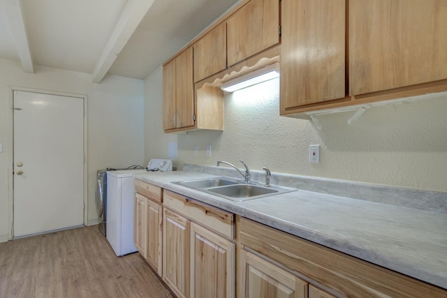 kitchen with independent washer and dryer, beam ceiling, light brown cabinetry, and sink