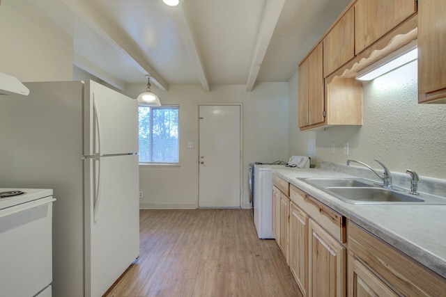 kitchen with light brown cabinetry, sink, and beamed ceiling