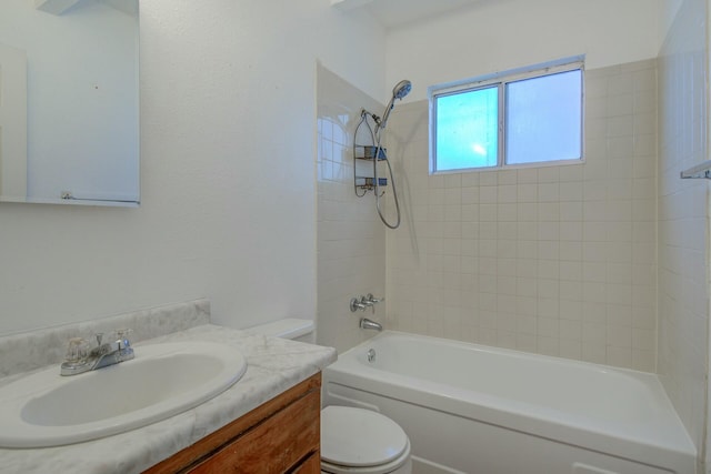 full bathroom with tiled shower / bath combo, vanity, and toilet