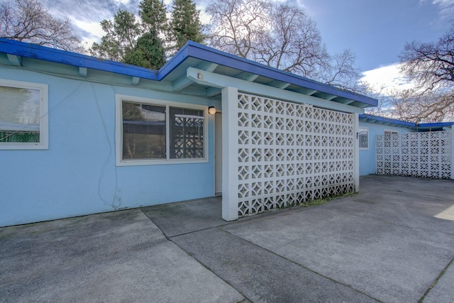 view of side of home with a patio area