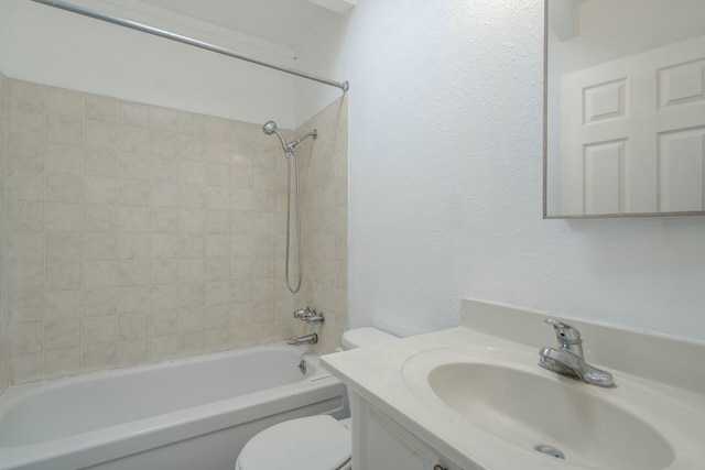 full bathroom with tiled shower / bath, vanity, and toilet