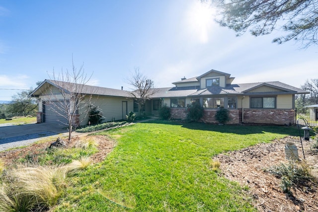 view of front of house featuring a garage and a front lawn