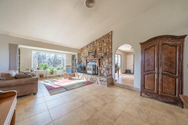 tiled living room with a healthy amount of sunlight and high vaulted ceiling