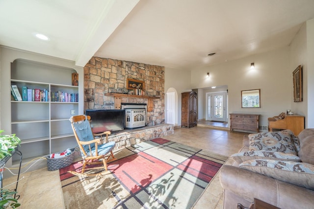 living room featuring beamed ceiling and tile patterned flooring