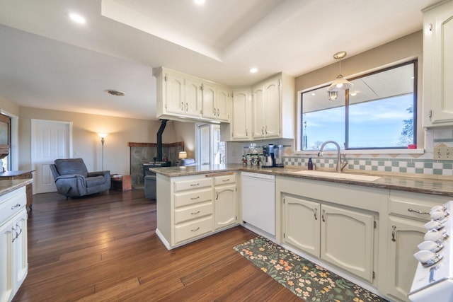 kitchen featuring sink, dark hardwood / wood-style floors, white dishwasher, kitchen peninsula, and white cabinets