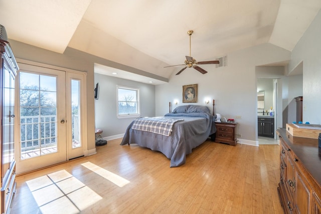 bedroom with vaulted ceiling, connected bathroom, access to exterior, and light wood-type flooring