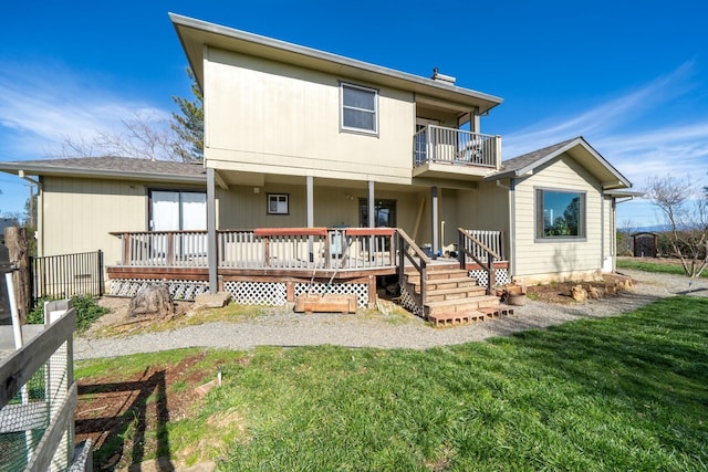 rear view of property with a yard and a balcony