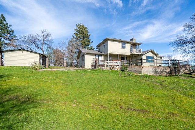 rear view of house featuring a lawn