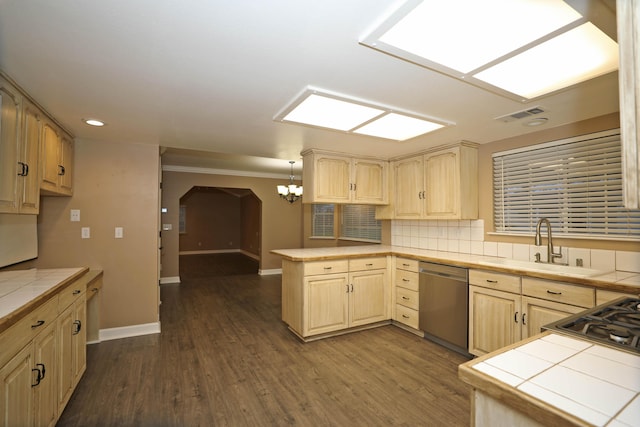 kitchen with kitchen peninsula, tile countertops, stainless steel dishwasher, and decorative light fixtures