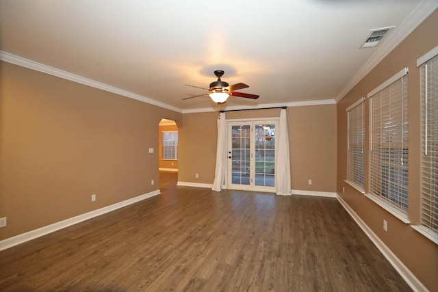 empty room with dark wood-type flooring, crown molding, and ceiling fan