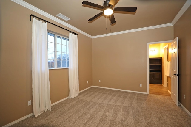 unfurnished bedroom featuring light colored carpet, ceiling fan, and ornamental molding