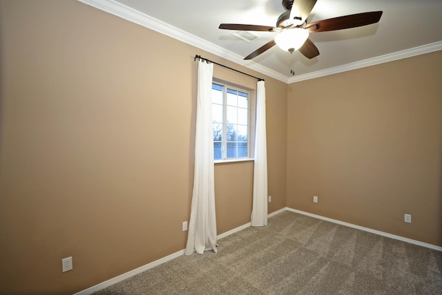 spare room with ornamental molding, carpet flooring, and ceiling fan